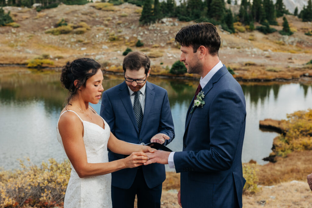 Colorado Elopement Photographer captures bride putting ring on groom