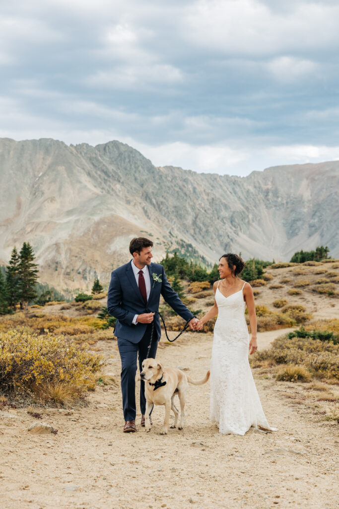 Colorado Elopement Photographer captures bride and groom walking together and holding hands