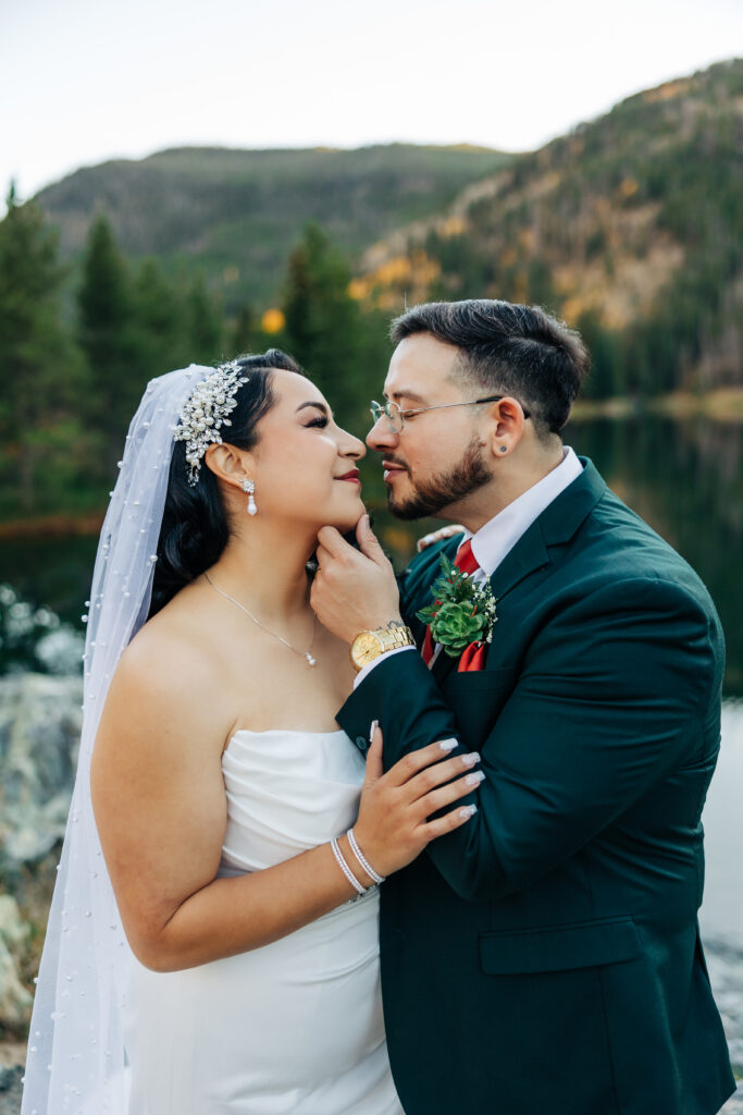 Colorado Elopement Photographer captures groom grabbing bride's chin to kiss her
