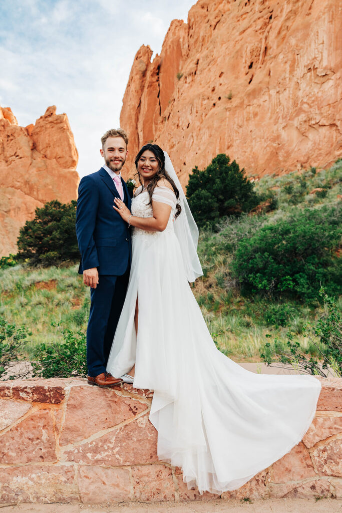 Denver Elopement Photographer captures bride and groom on wall standing together