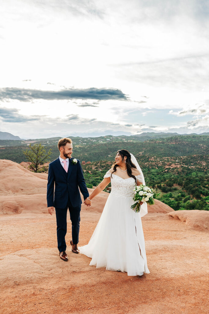 Colorado Elopement Photographer captures bride leading groom during outdoor bridal portraits after adventure elopement ceremony