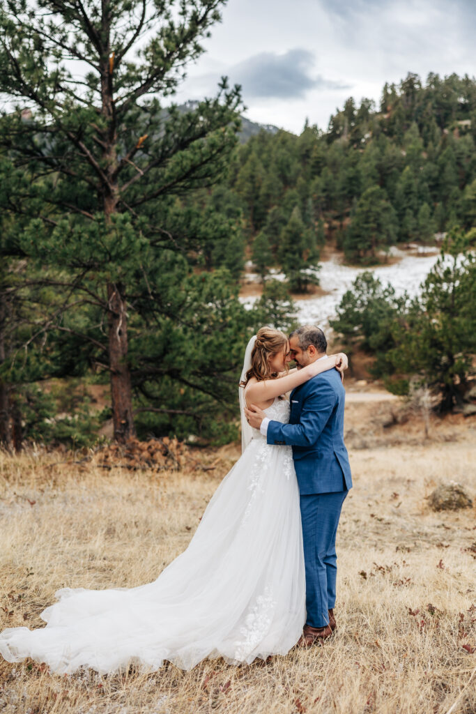 Denver Elopement Photographer captures bride and groom embracing in mountains 