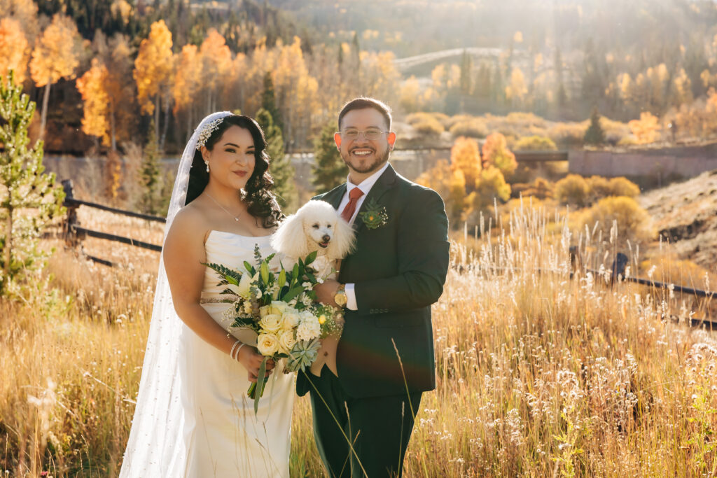 Colorado Elopement Photographer captures bride and groom holding dog on wedding day
