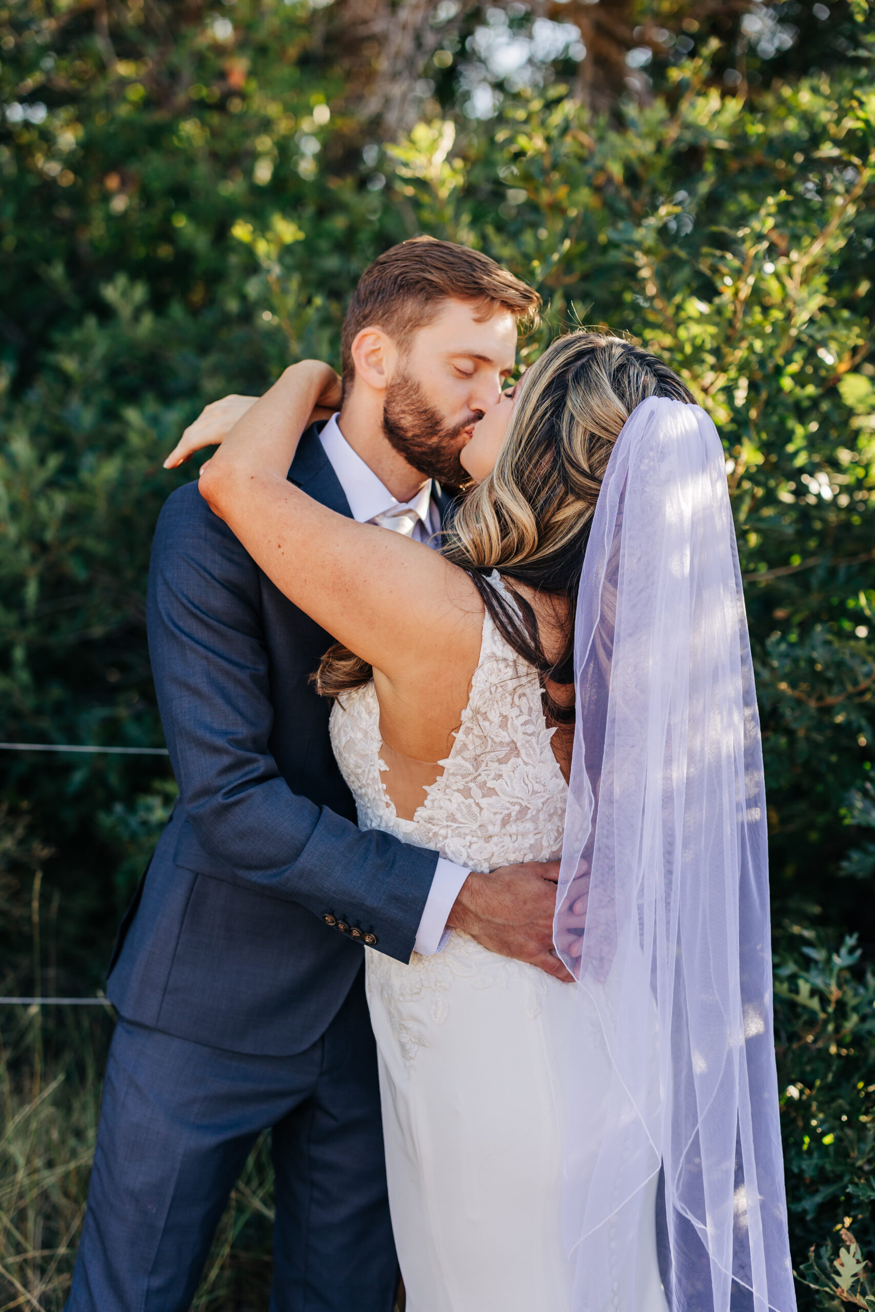 Denver Elopement Photographer captures bride and groom embracing while bride kisses groom