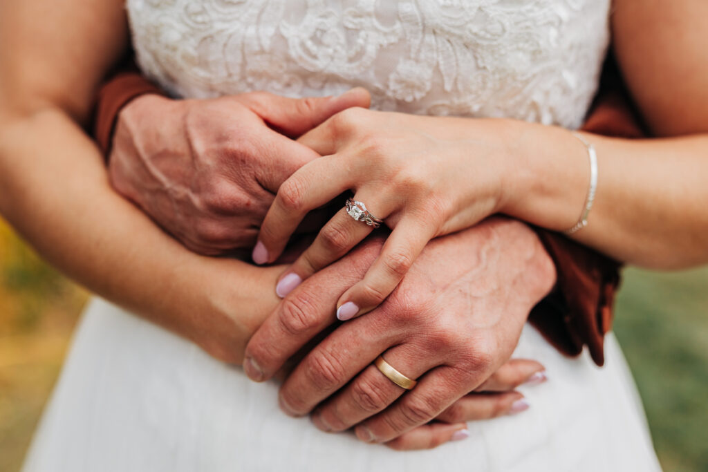 Denver Elopement Photographer captures bride and groom holding hands around bride's waist