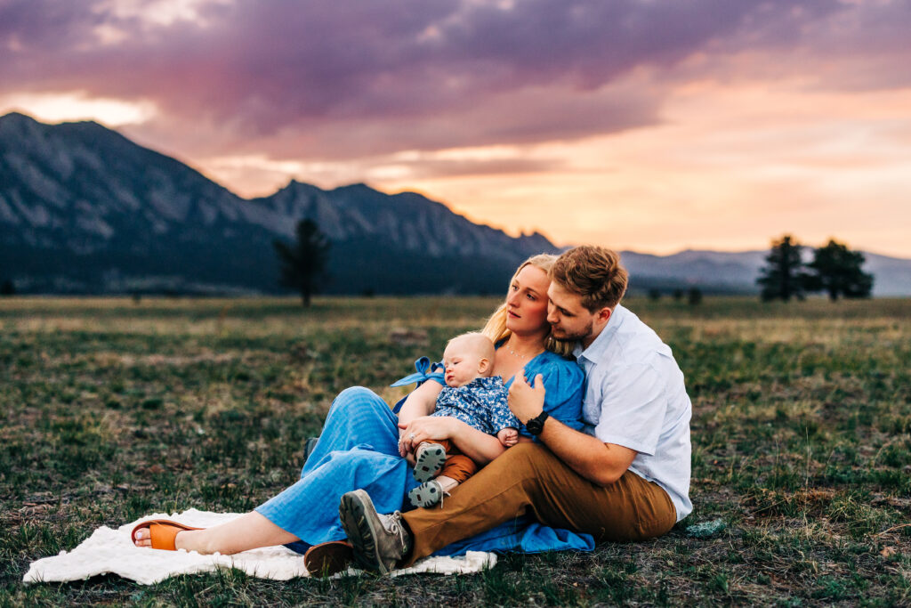 Denver Family Photographer captures family sitting on blanket together at sunset