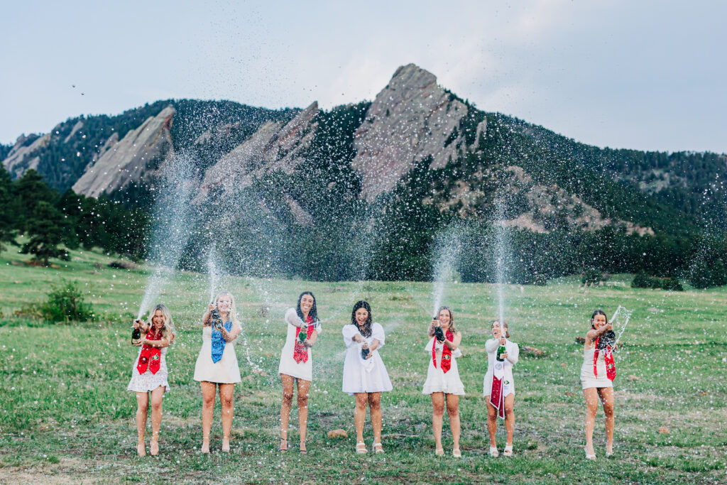 Colorado Senior Photographer captures group of grads popping champagne together