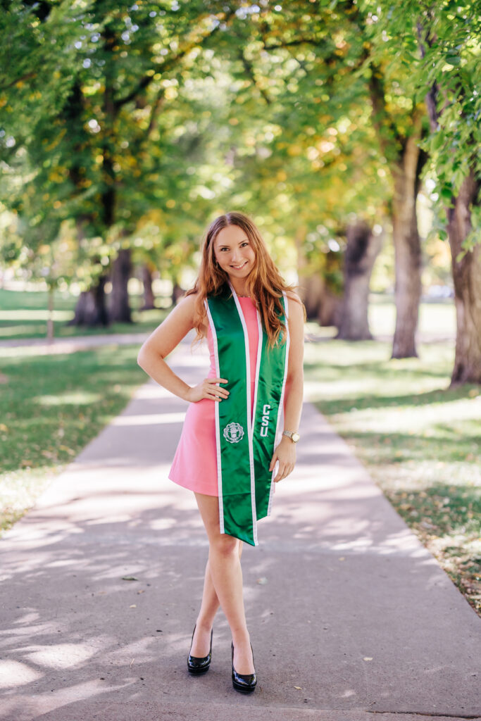 Colorado Senior Photographers capture young woman standing with robes on her