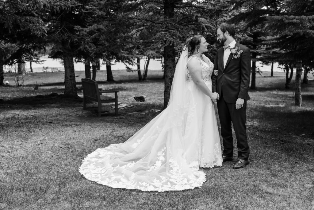 Bride and groom looking at one another during outdoor bridal portraits after intimate ceremony