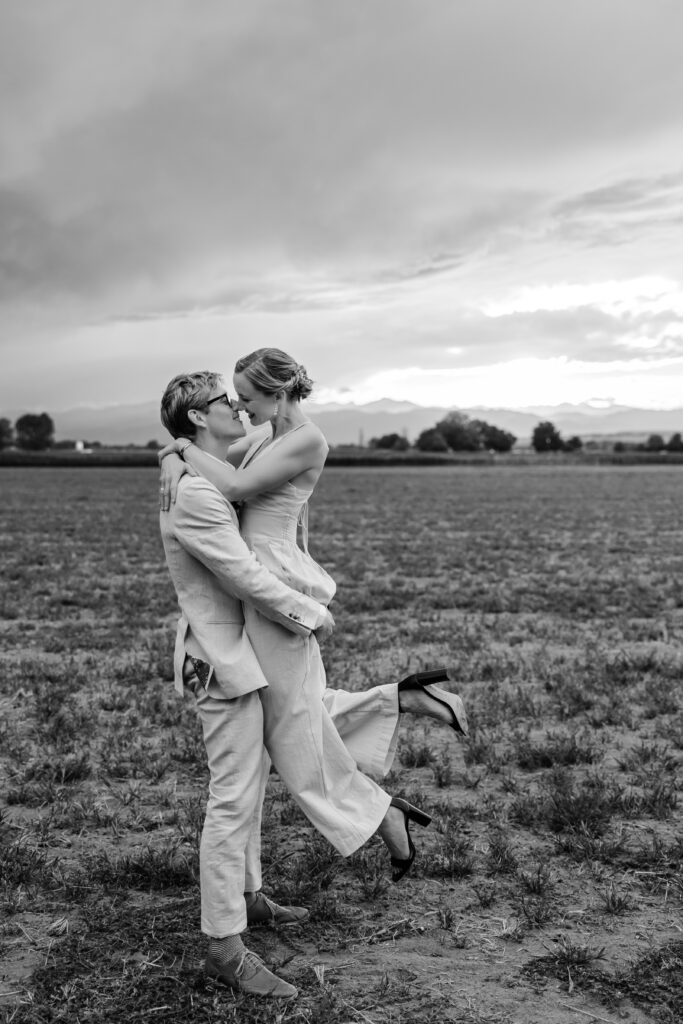 Denver Elopement Photographer captures groom lifting bride and kissing her