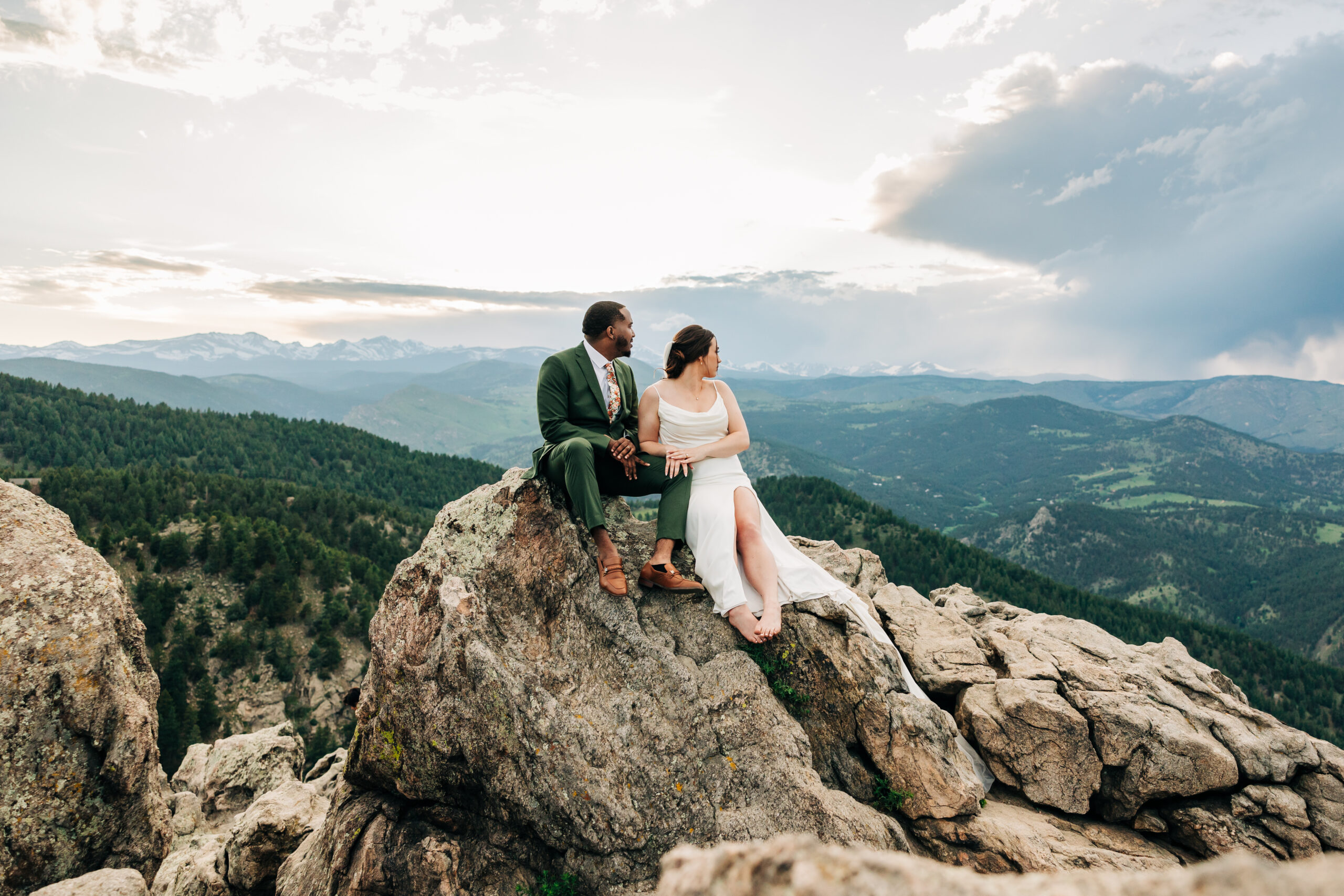 Boulder Wedding Photographer captures bride and groom sitting on rock