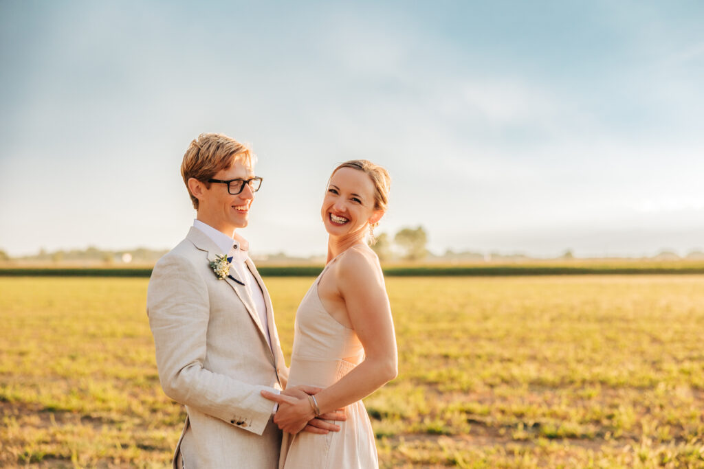 Denver Elopement Photographer captures bride laughing with groom during portraits after planning wedding timeline template