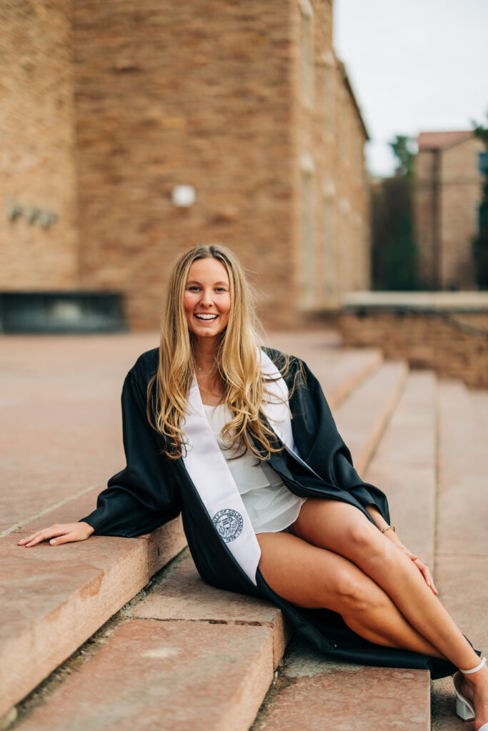 Colorado senior photographers capture woman sitting on stairs smiling