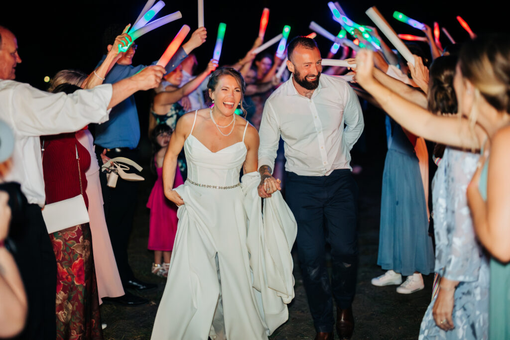 Colorado Wedding Photographer captures bride and groom leaving with lights above them