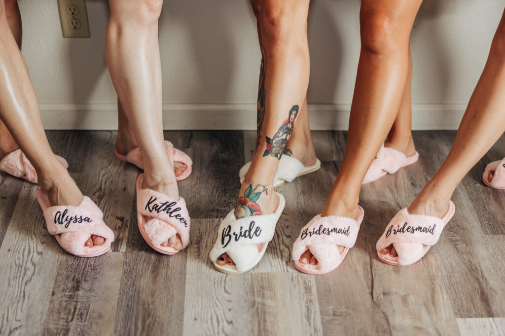 Boulder Wedding Photographer captures bride and bridesmaids wearing matching slippers