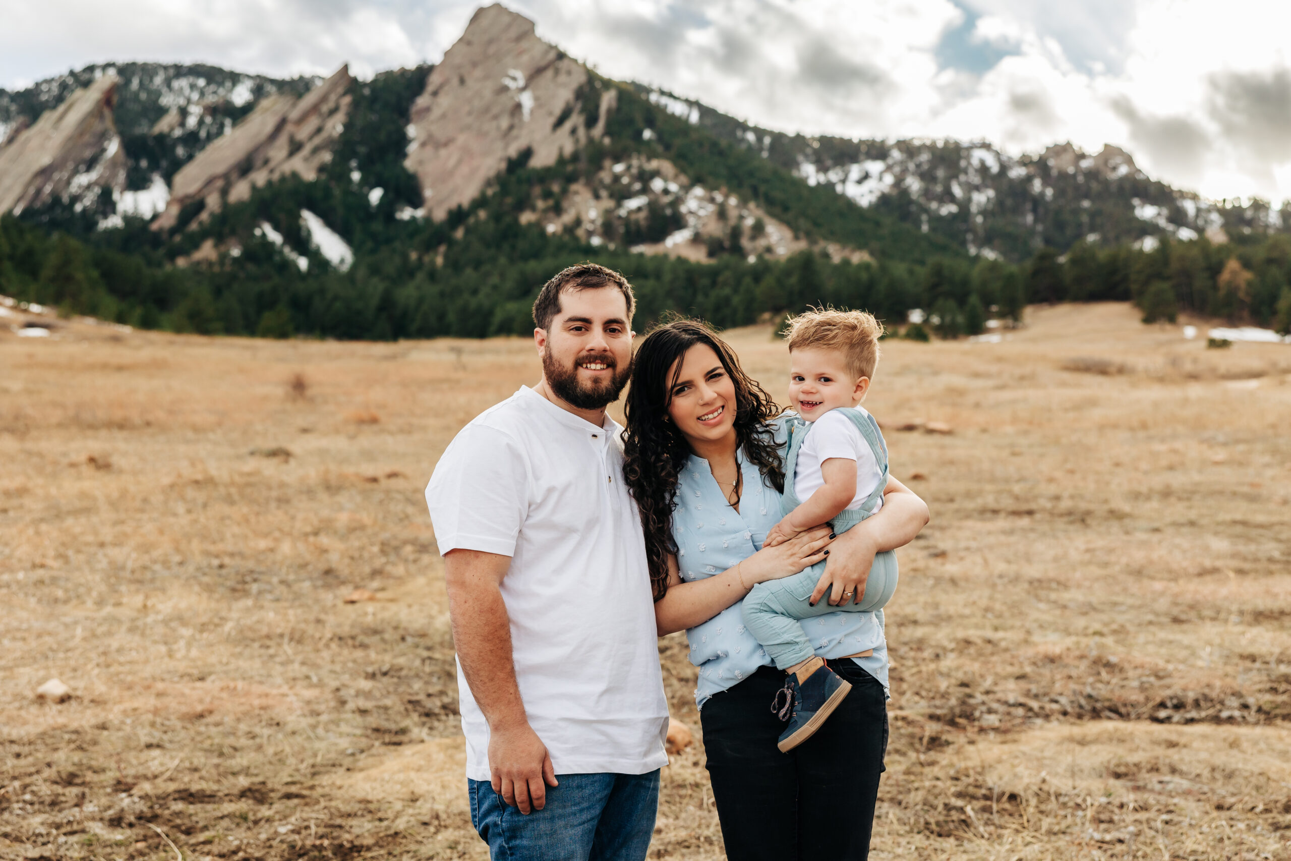 Denver Family Photographer captures young family holding baby during outdoor family photos