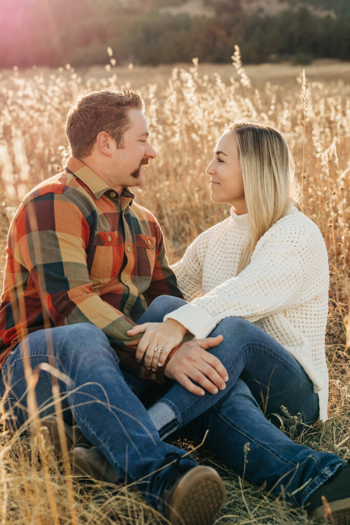 Denver wedding photographer captures couple sitting in tall grass