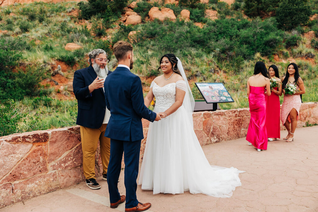 Colorado Elopement Photographer captures bride and groom holding hands during intimate ceremony