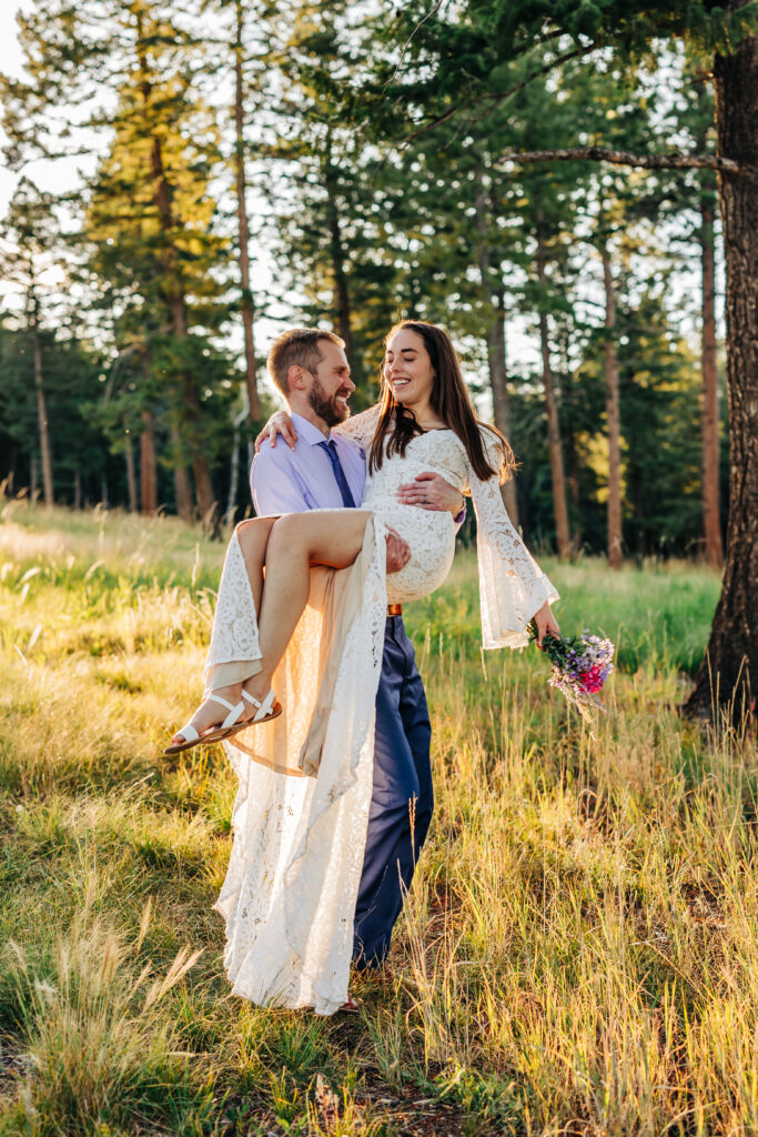 Boulder Wedding Photographer captures bride and groom together while groom lifts bride