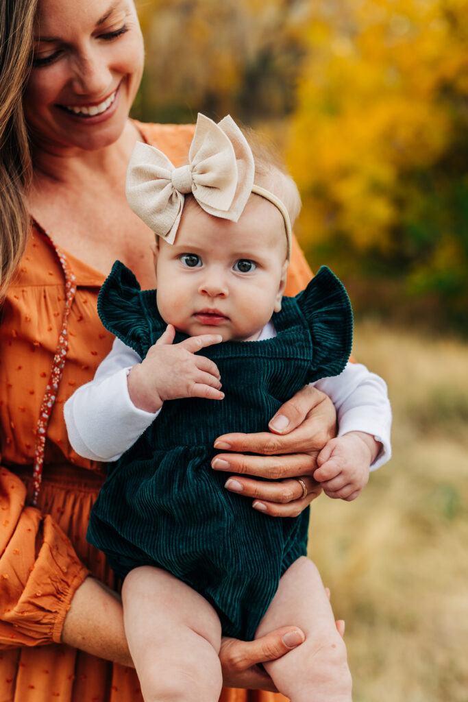 Denver Family Photographer captures mother holding baby girl during outdoor family photos