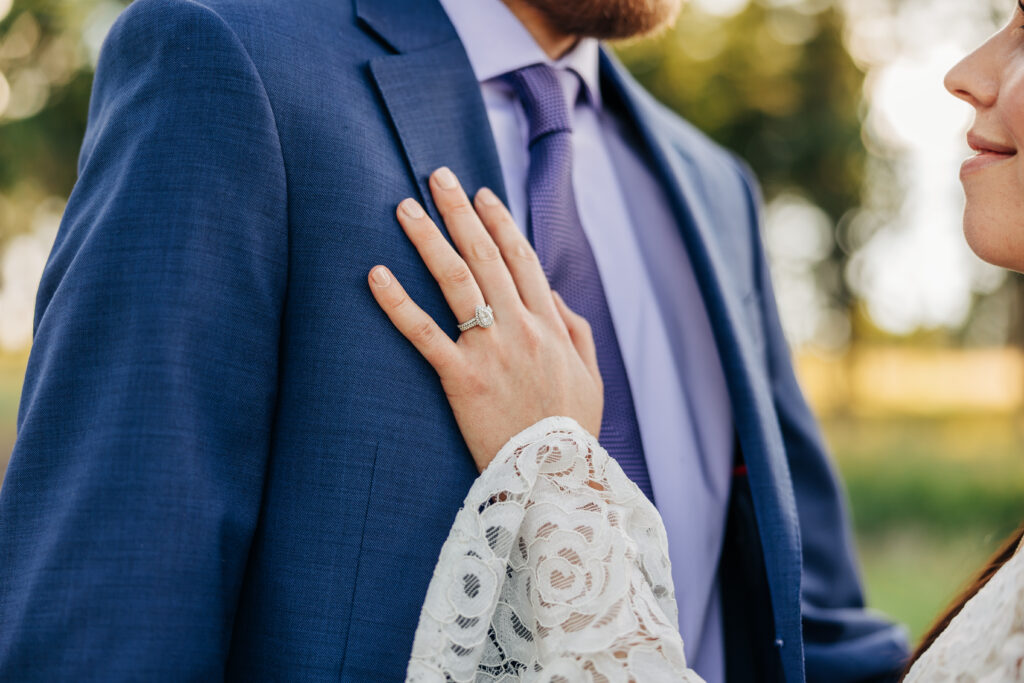 Boulder Wedding Photographer captures bride placing hand on groom's chest to show wedding ring