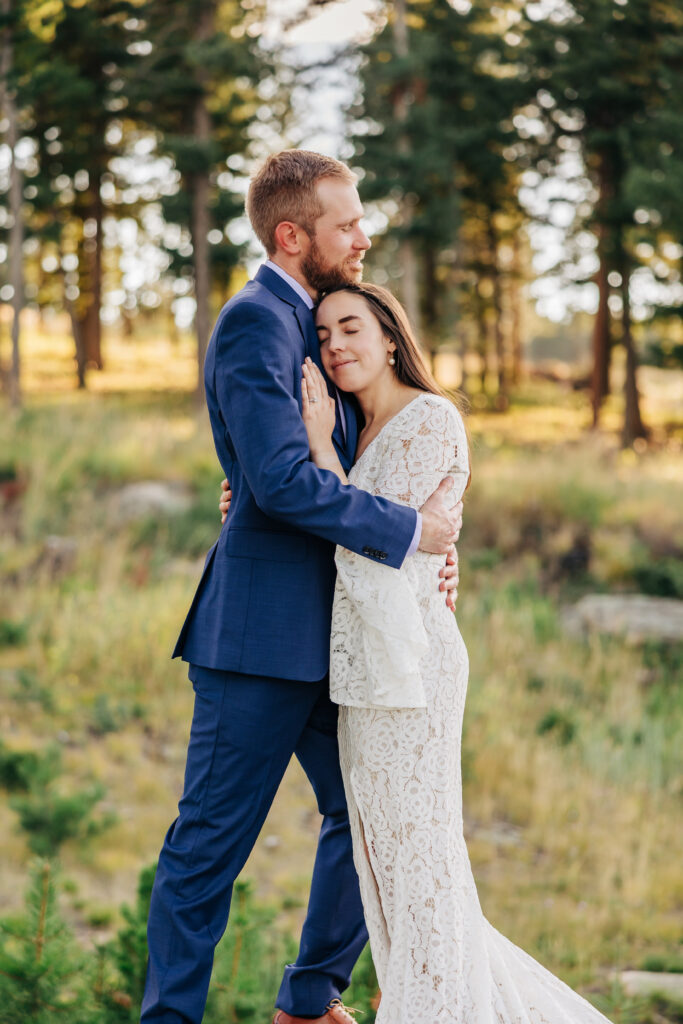 Boulder Wedding Photographer captures bride and groom standing together and embracing