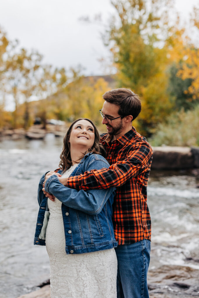 Denver Engagement Photographer captures woman looking up at man during engagement photos