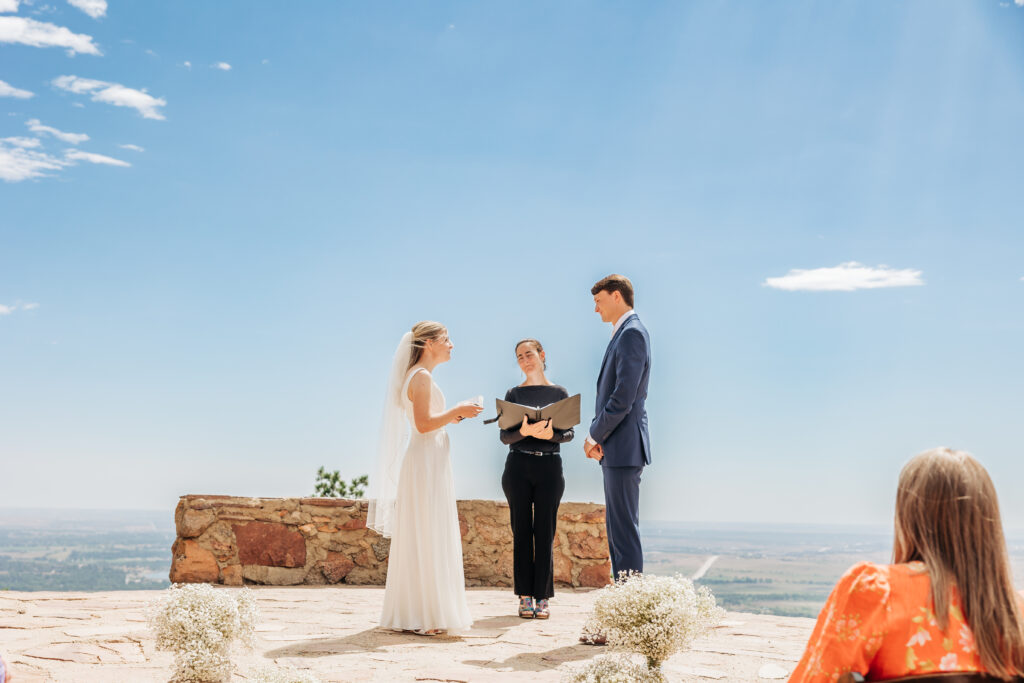 Boulder Wedding Photographer captures bride reading vows during intimate ceremony