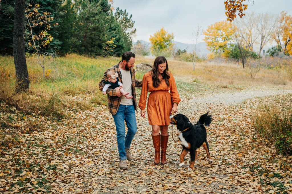 Denver Family Photographer captures young family walking in park with dog 