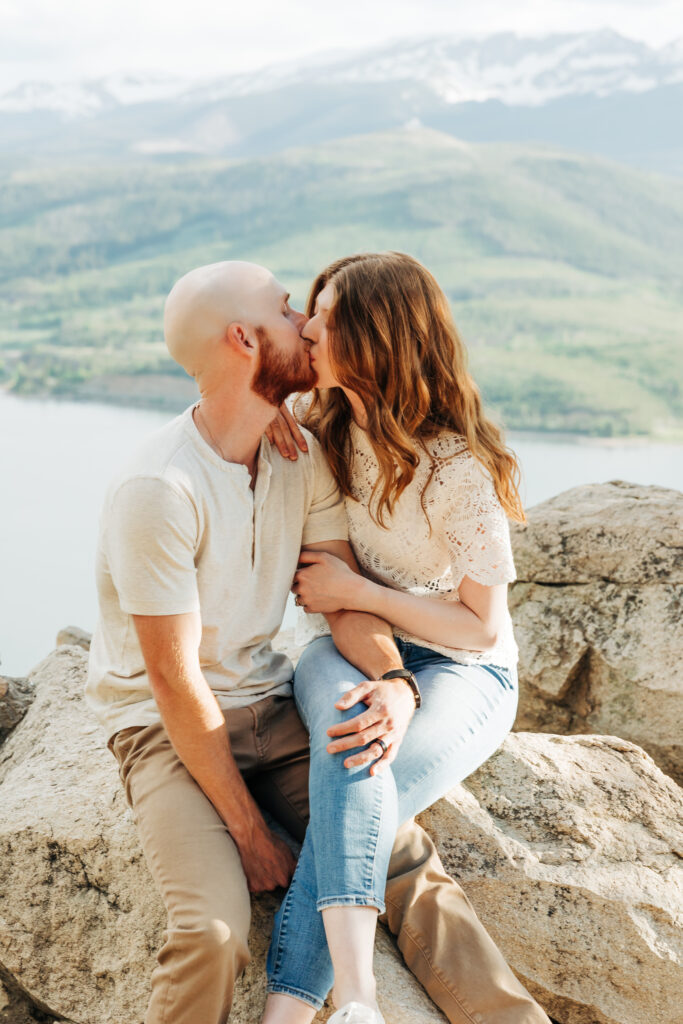 Woman sitting on man's lap in Colorado mountains