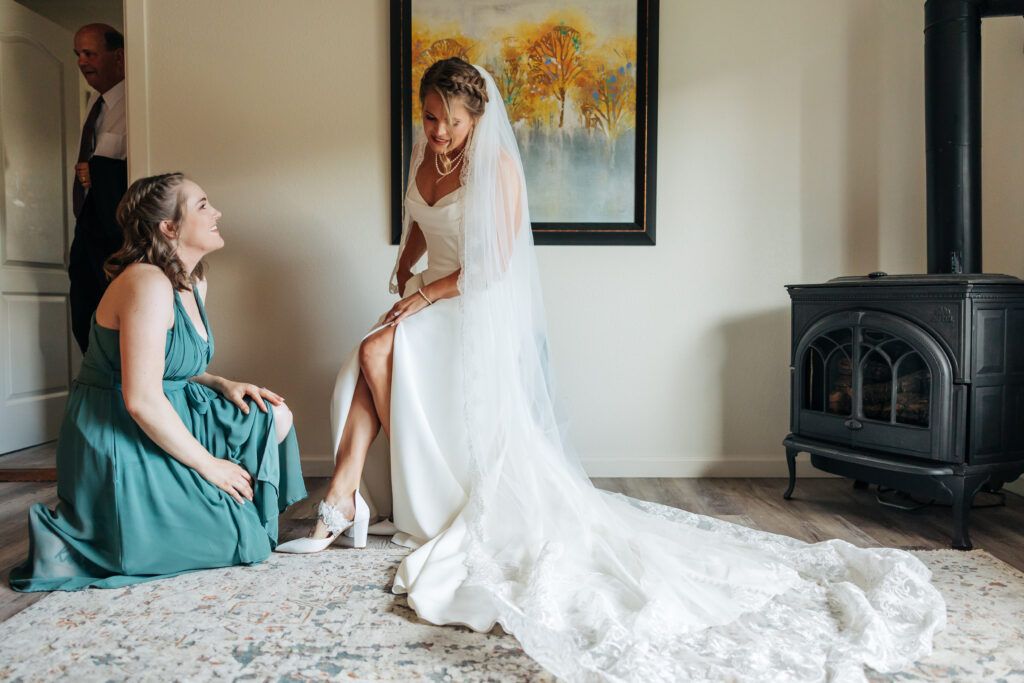 Boulder Wedding Photographer captures bride getting shoes put on