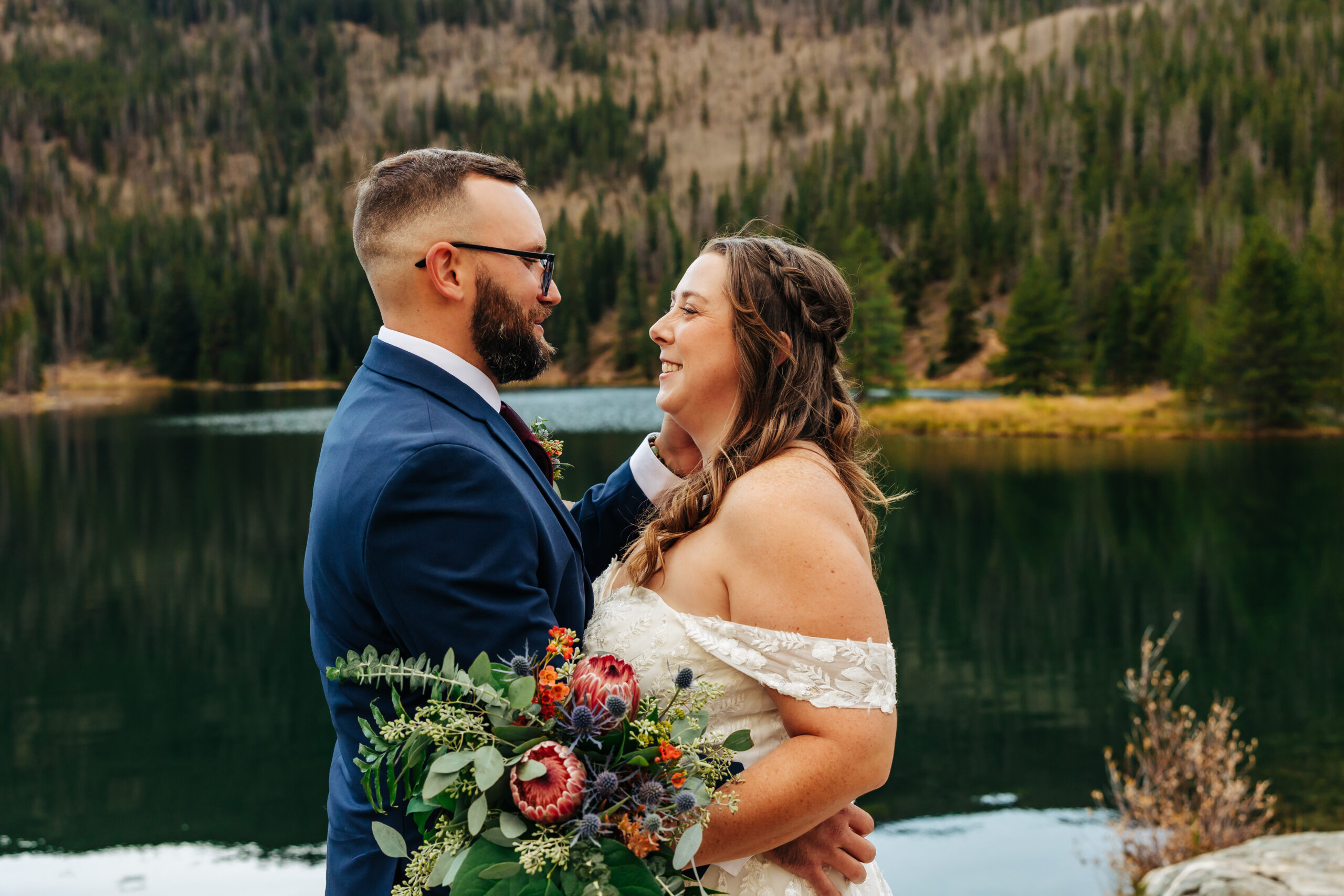 Colorado Elopement Photographer captures bride and groom laughing together after intimate ceremony