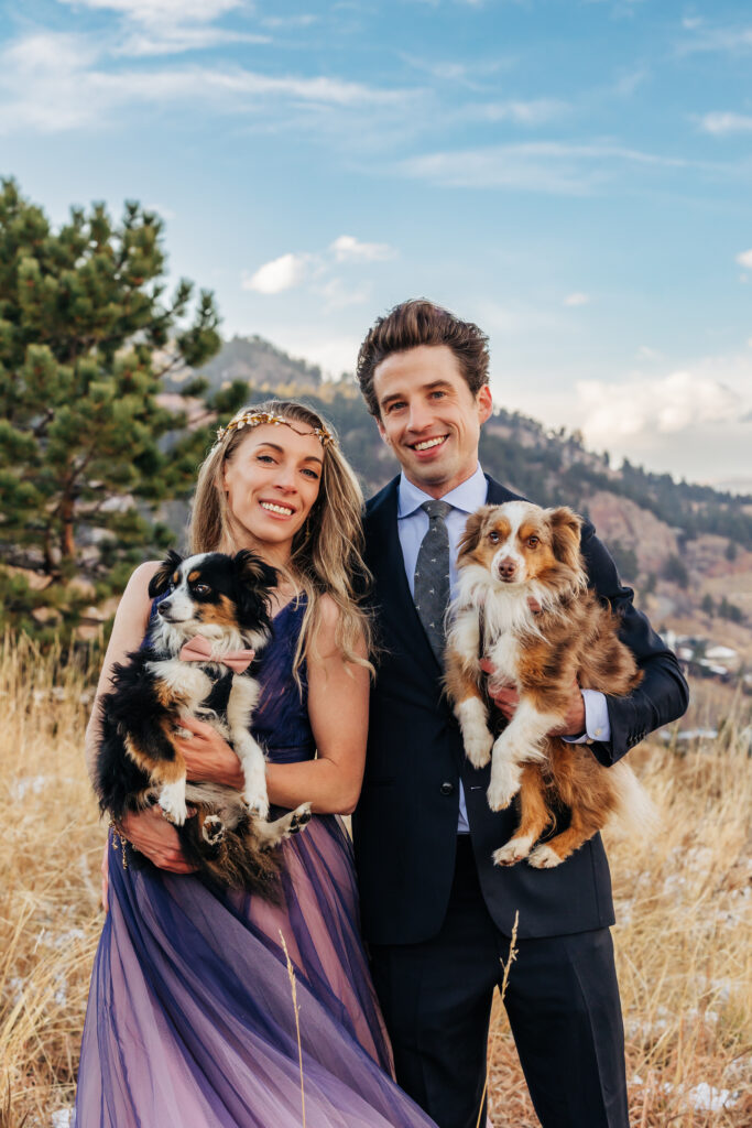 Colorado Elopement Photographer captures bride and groom holding pups during bridal portraits