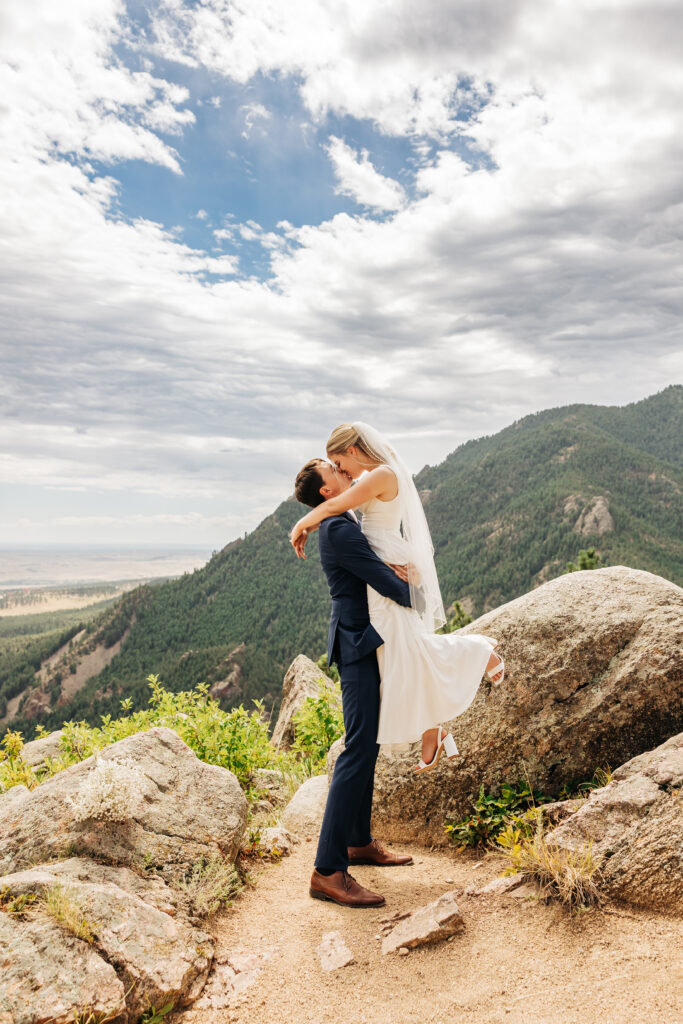 Boulder Wedding Photographer captures groom lifting bride and kissing her