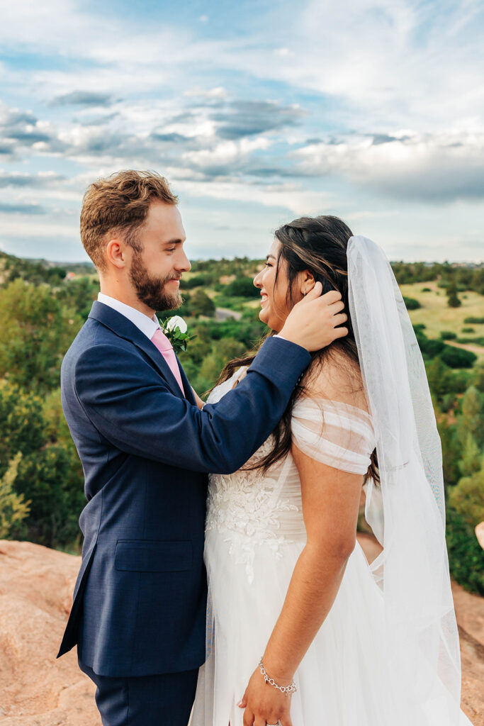 Colorado Elopement Photographer captures groom holding bride's cheek