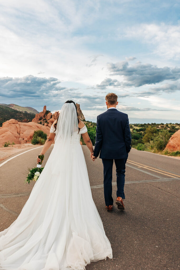 Colorado Elopement Photographer captures couple holding hands and walking away together