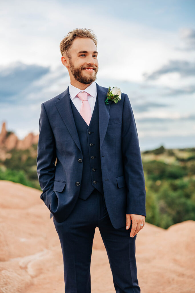 Colorado Elopement Photographer captures groom with hands in pockets looking at scenery