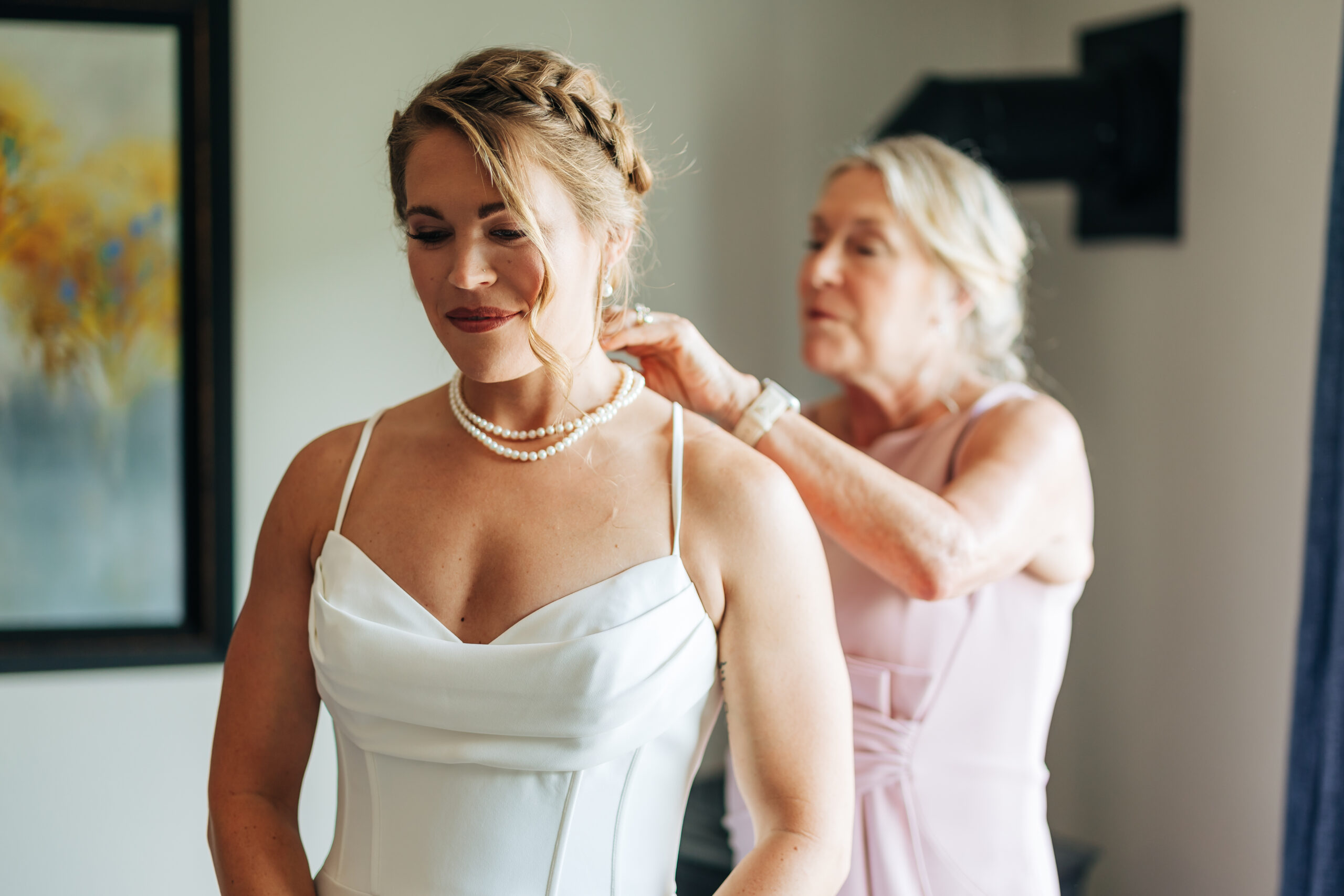 Colorado Elopement Photographer captures mother putting necklace on bride
