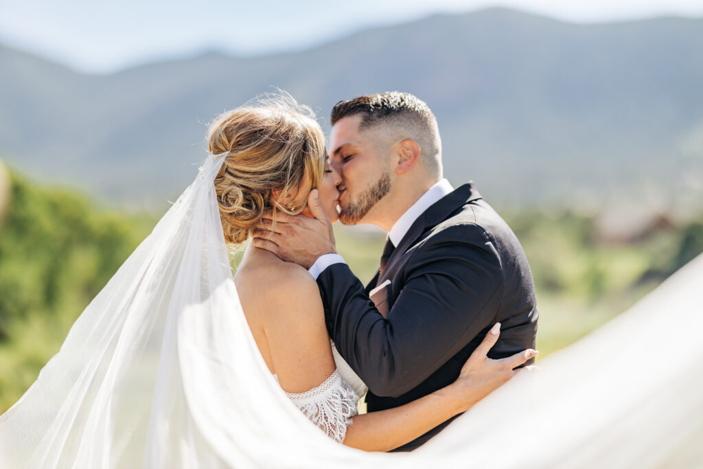 Boulder Wedding Photographer captures groom kissing bride on wedding day