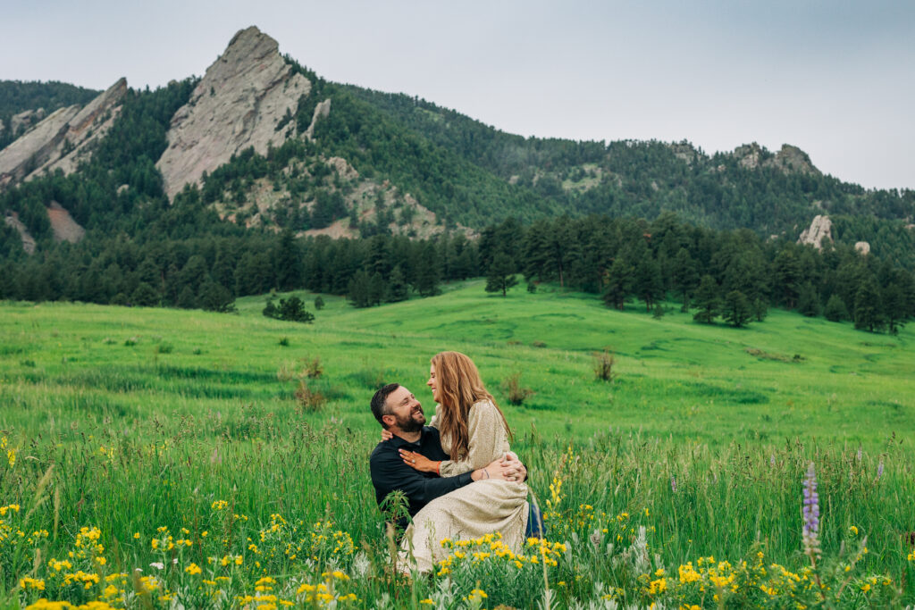 Denver Wedding Photographer captures couple sitting in grass together