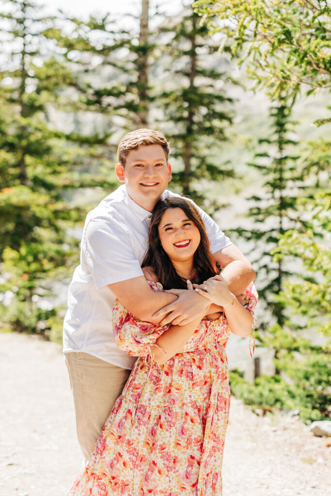 Denver Wedding Photographer captures man hugging woman from behind during spring engagement photos