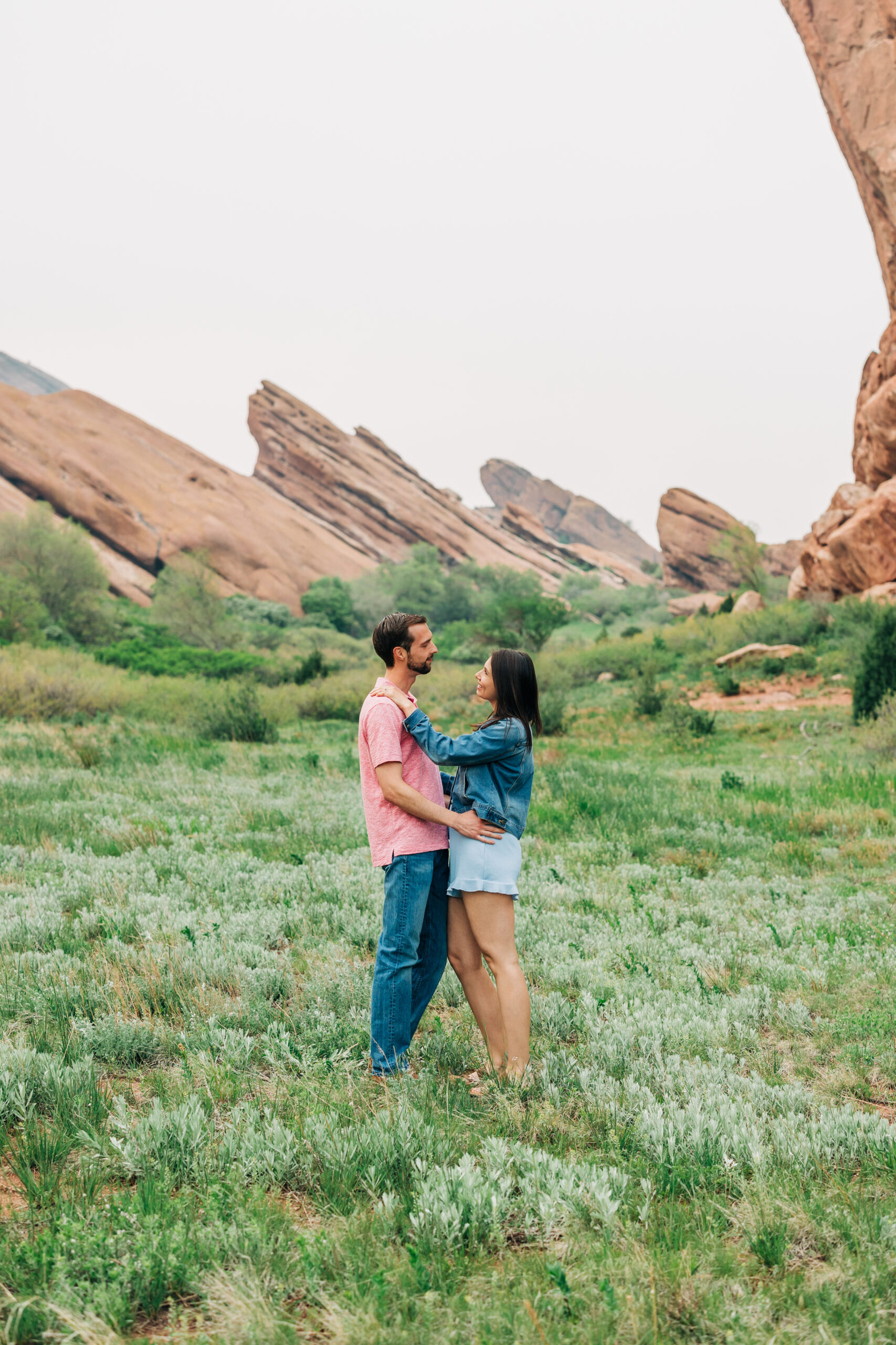 Denver Wedding Photographer captures man and woman standing together looking at one another during spring engagement photos