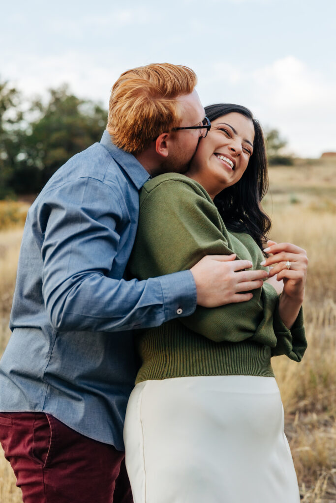 Colorado Elopement Photographer captures man hugging woman from behind and making her laugh