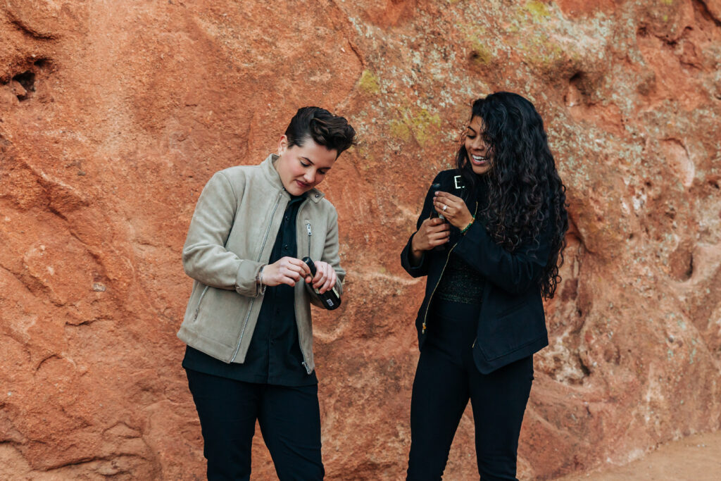 Denver Wedding Photographer captures women opening champagne after surprise proposal