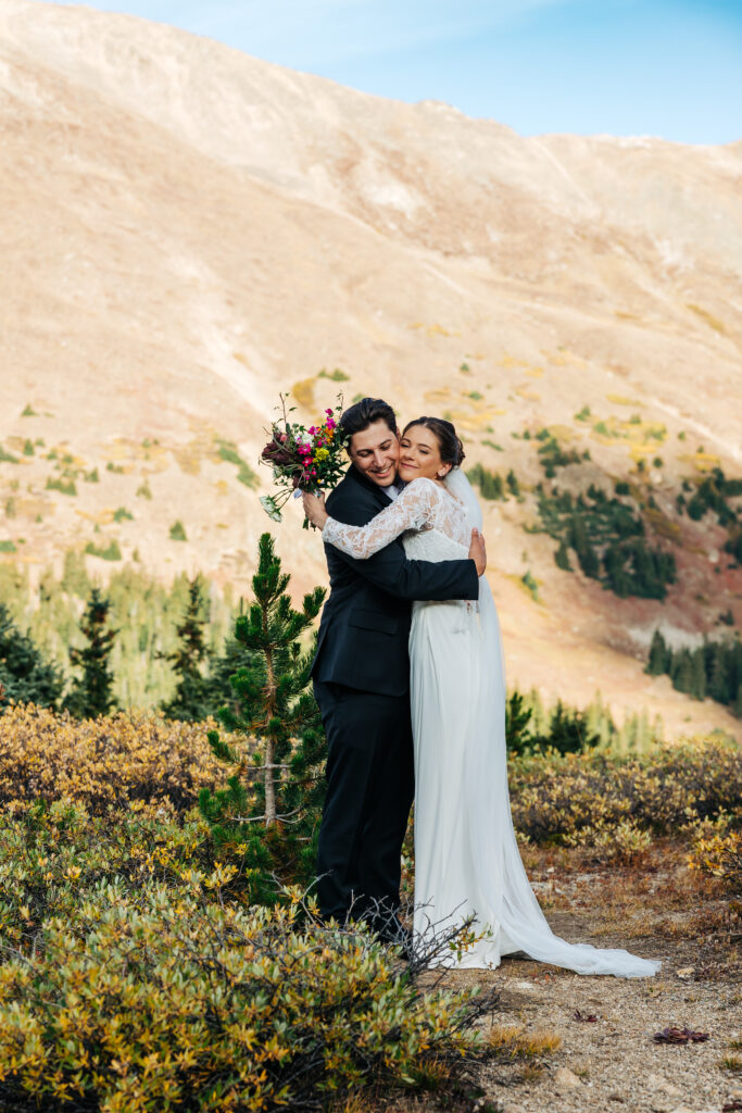 Colorado Elopement Photographer captures bride and groom hugging after ceremony