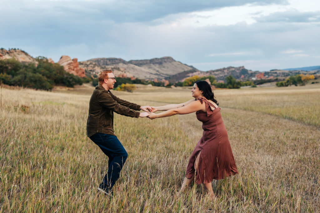 Colorado Elopement Photographer captures couple spinning and having fun during outdoor engagement photos