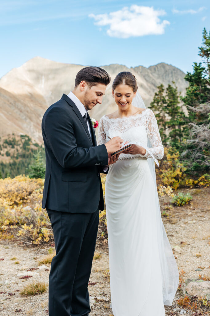 Colorado Elopement Photographer captures bride and groom signing marriage license