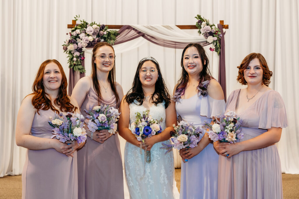 Denver Elopement Photographer captures bride smiling with bridesmaids after wedding