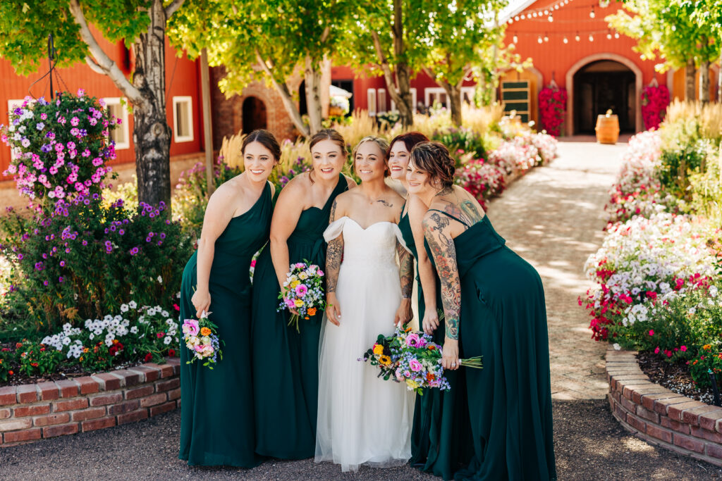 Colorado Elopement Photographer captures bride with bridesmaids smiling and celebrating