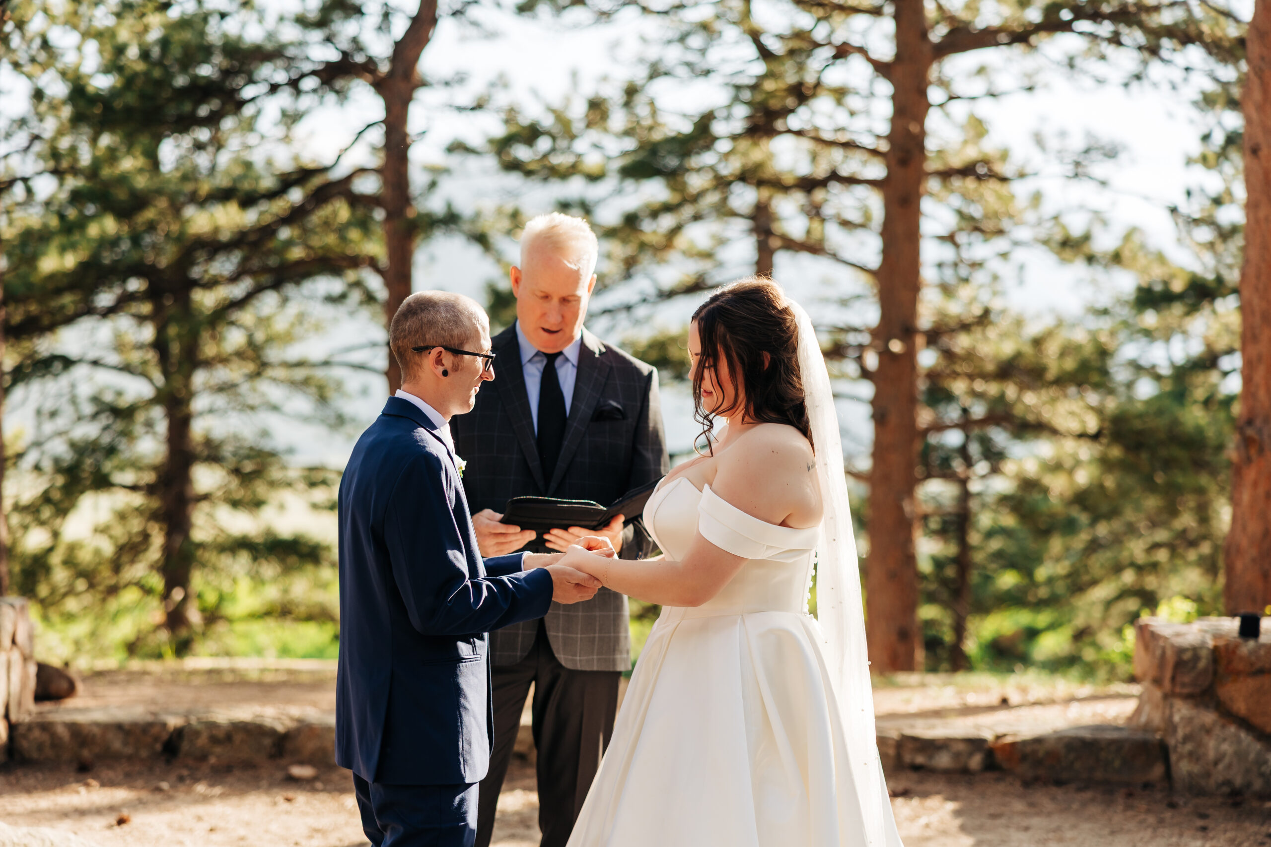 Intimate wedding vows exchanged in a serene forest setting, beautifully documented by a Denver elopement photographer.